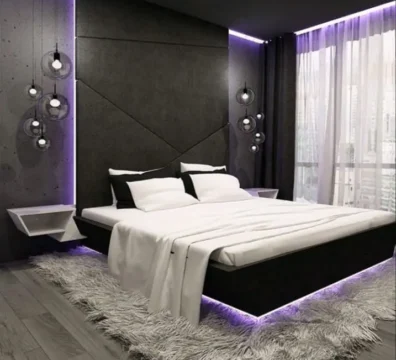 Chambre au design ultra-moderne avec un lit plateforme noir doté d'un éclairage LED violet et une tête de lit murale géométrique. Ameublement Hicham Marrakech.