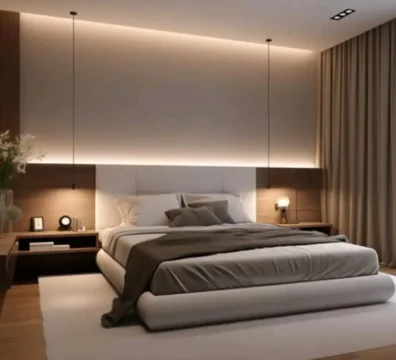 Lit au design minimaliste et moderne avec un cadre arrondi et une tête de lit blanche, intégré dans un panneau mural en bois avec éclairage d'ambiance. Ameublement Hicham.